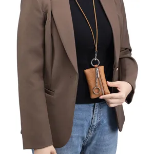 Stylish brown genuine leather neck pouch for coins and keys worn by a model in studio