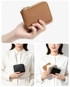 Hand holding and model displaying cross-grain leather mini zip-around wallets