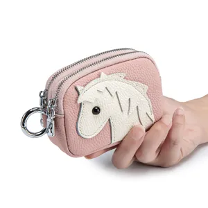 Compact pink leather coin purse with cute white horse design and double zippers.