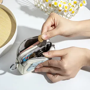 Compact leather coin purse featuring double zippers and a cute cartoon pony design