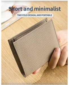 Close-up of minimalist two-fold genuine leather wallet with pebbled texture detail.