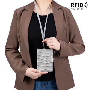 Crocodile pattern leather passport holder with neck strap and RFID protection feature.