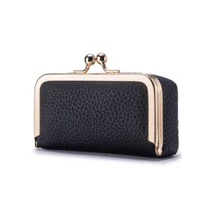 Elegant black genuine leather mini jewelry pouch featuring a vintage gold kiss-lock closure
