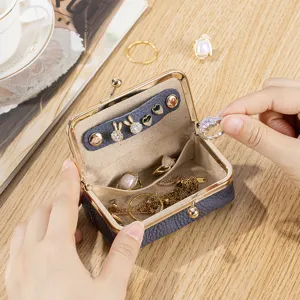Compact grey leather jewelry organizer with kiss-lock closure for rings and earrings
