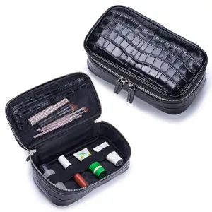 Black crocodile pattern leather makeup bag with double zippers and organized interior.