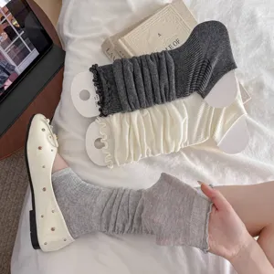 Breathable slouchy leg warmers with sweet lettuce edge detail in grey and cream