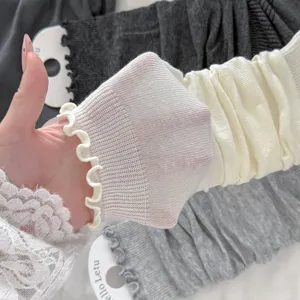 Detailed macro view of thin breathable leg warmers with sweet ruffled edge design