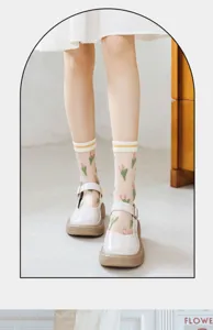 Close-up of elegant sheer white socks with pink tulip embroidery and cotton sole