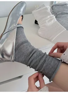 Grey knit stacked socks detail shot, paired with stylish silver ballet flats, lightweight design.