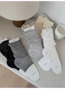 Detailed view of lightweight stackable socks in multiple colors with neat packaging.