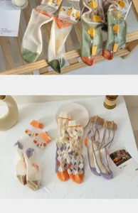 Detail view of various sheer floral glass silk socks in a Japanese aesthetic style