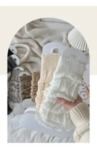 Knit leg warmers detail featuring cable pattern and lettuce edge design for winter style.