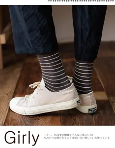 Detailed macro view of brown and white striped cotton socks on model
