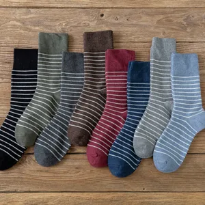 Retro cotton striped mid-calf socks for men in multiple colors on wooden background.