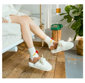 Warm white plush Christmas socks and cute reindeer slippers worn in a cozy bedroom