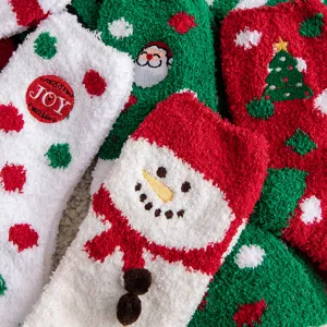 Close-up detail of festive Christmas fuzzy socks with snowman and tree patterns