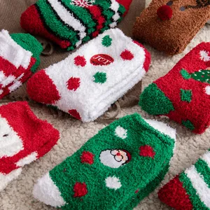 Close-up of festive coral fleece Christmas socks with Santa and reindeer patterns