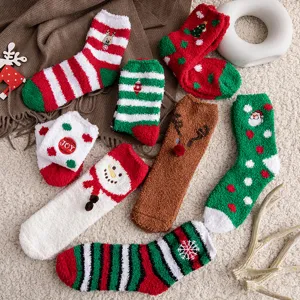Detail view of cozy Christmas themed coral fleece socks featuring Santa and reindeer designs