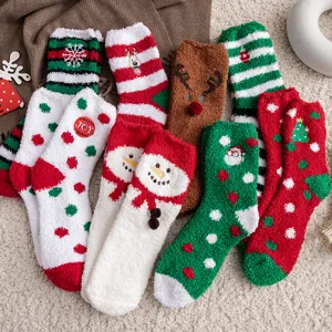 Detailed view showing multiple pairs of cozy coral fleece Christmas socks with festive patterns