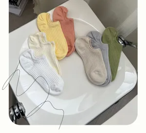 Detail view of candy-colored ribbed cotton low-cut socks in a variety of pastel tones.