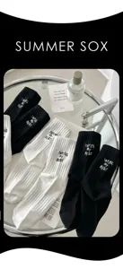 Classic black and white mid-tube cotton socks with chic embroidered letters for women.