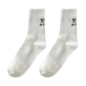 White cotton mid-calf sports socks with black embroidered letters, main view showcase