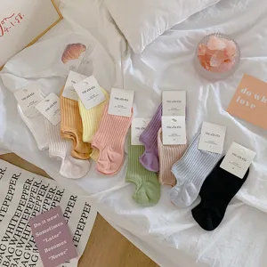 Collection of dopamine color invisible cotton boat socks displayed on white bedding