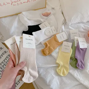 Detailed view of multiple pairs of colorful low-cut cotton ankle socks with packaging tags