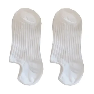 Pair of plain white ribbed invisible boat socks with a low-cut design for summer