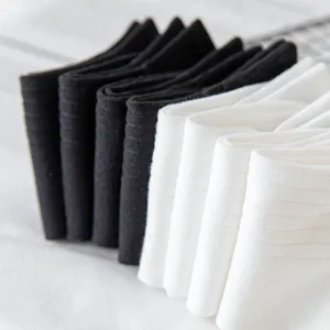 Detailed close-up view of neatly folded black and white ribbed cotton socks for daily wear.