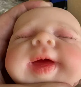 Detailed macro shot of a 12-inch lifelike solid silicone reborn baby doll face