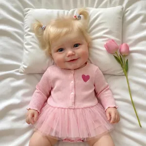 Detailed view of a 20-inch Maddie reborn doll wearing a pink heart tutu outfit and cardigan