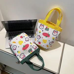 Close-up of cute cartoon canvas tote bags with rabbit prints and colorful handles.