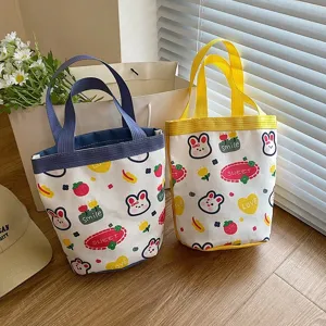Cute cartoon canvas lunch bags with rabbit and strawberry patterns in lifestyle setting