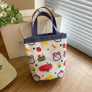 Close-up of a cute cartoon canvas tote bag featuring lovely rabbit and strawberry patterns