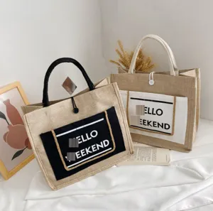 Detail showing large capacity linen tote bags with Hello Weekend print and round handles