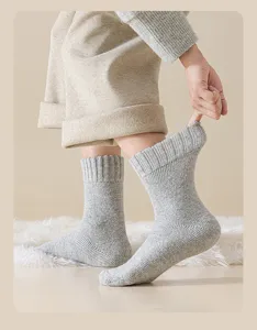 Close-up view of thick grey wool socks for men featuring comfortable elastic rib cuffs