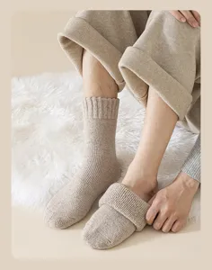 Cozy oatmeal wool-blend thick socks shown on a soft white faux fur rug.