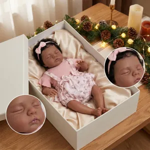 Close-up detail of a 19-inch sleeping reborn baby doll wearing a floral romper.