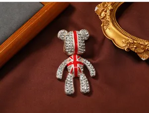 Gedetailleerde weergave van teddybeerbroche met strassteentjes en Union Jack-motief