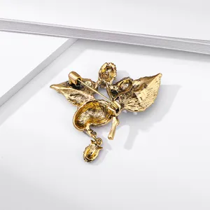 Vintage gold-tone magpie bird brooch with strawberry dangle and safety pin back
