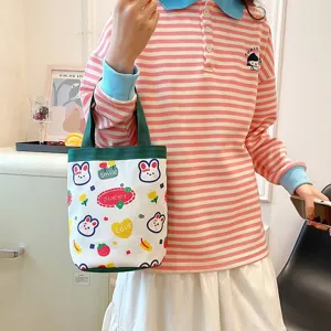 Detailed view of a cute cartoon canvas tote bag featuring rabbit prints and sweet text