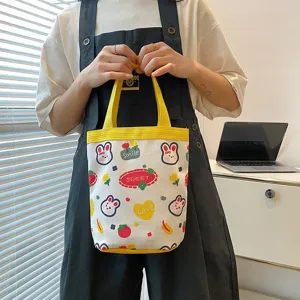 Cute cartoon canvas tote bag with bunny prints and yellow handles for lunch or daily use.