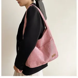 Detail of the pink corduroy tote bag showing its ribbed texture and large capacity