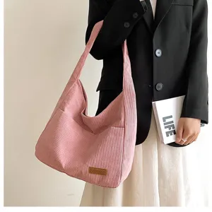 Detailed macro shot of the pink corduroy material texture on an oversized fashion tote bag
