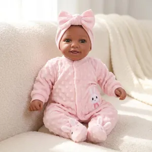 Realistic 17-inch reborn baby doll wearing a pink bunny jumpsuit and matching headband