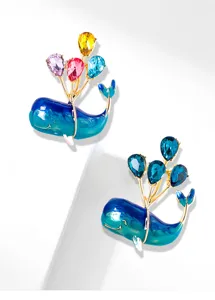 Detailed view of whale balloon brooch with colorful crystals and blue enamel finish.