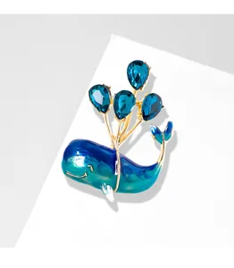 Detailed view of the blue whale brooch featuring sparkling balloon-shaped crystals