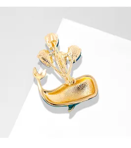Detailed back view of a gold-plated whale brooch featuring a secure pin clasp