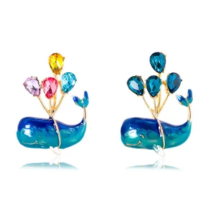 Whale brooch set with colorful balloon-shaped crystals on white background